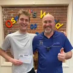 Smiling patient with Dr. Wully thumbs-up!